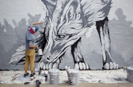 Artist Alexander Landerman works on the mural on the west-facing wall of Divepoint Scuba in downtown Stevens Point, Wednesday, Sept. 16, 2015.